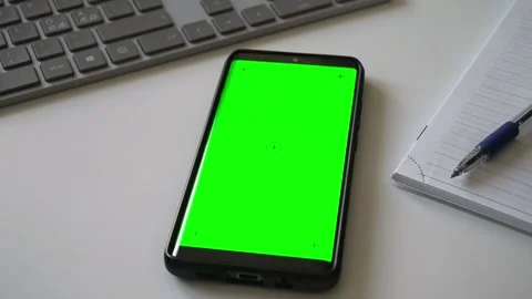 Smartphone with green screen chromakey on white desk. Stock Footage 340890439