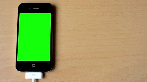 Smartphone - green screen - connect cable - table Video stock 44419333