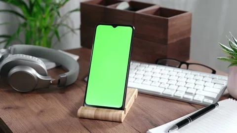 Smartphone with green screen on a desk Stock Footage 168259099