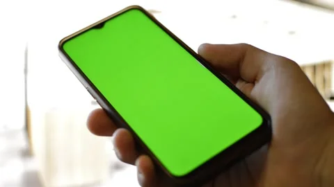 Smartphone with green screen display in a blurred modern house. 스톡 동영상 220419817