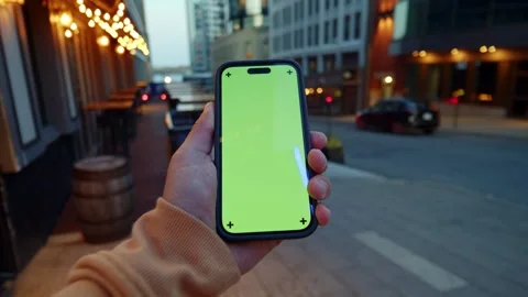Smartphone Green Screen Display In Hand With Bright City Night Life Background Stock Footage 314114244