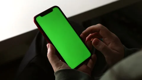 Smartphone with green screen in hands close-up, movement of fingers, mock-up on Stock Footage 161026771