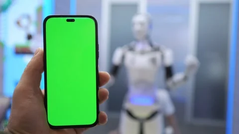 Smartphone with Green Screen Held Up in Front of Robot in Modern Technology Video stock 277781090