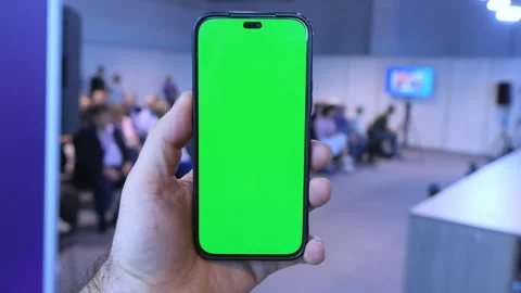 Smartphone with green screen held in hand at event Stock Footage 346150334