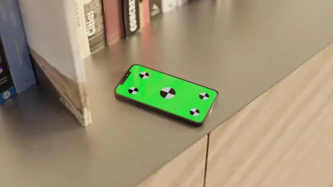 Smartphone with a Green Screen on the table with books Stock Footage 253631785