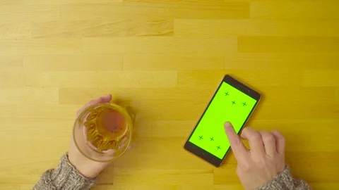 A smartphone with green screen on the table Video stock 80921332