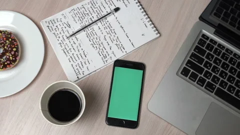 Smartphone With Green Screen On Workplace Table. Top View Stock Footage 91662395
