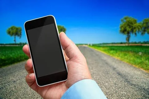Smartphone in hand with a blank area to insert a custom image. Beautiful l... Stock Photos