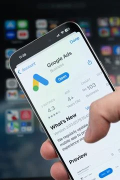 Smartphone in hand with Google ads app on screen Stock Photos