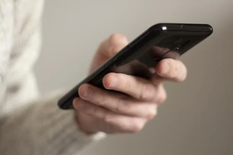 Smartphone in the hand of a man Stock Photos
