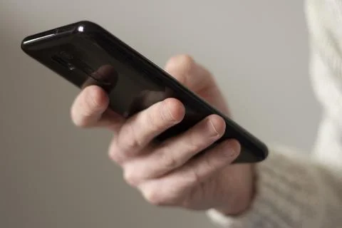 Smartphone in the hand of a man Stock Photos