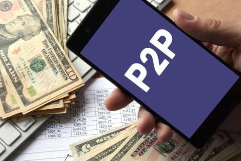 Smartphone in hand with message P2P. Peer to peer lending concept. Stock Photos