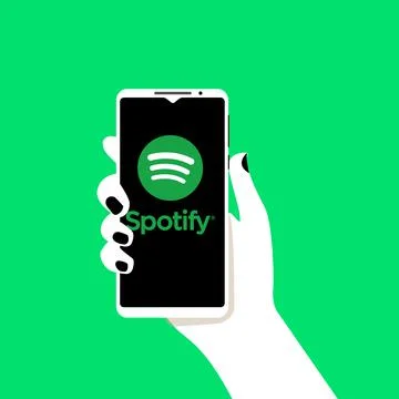 Smartphone in hand with Spotify app open. Spotify is a music service that off Ilustração Stock