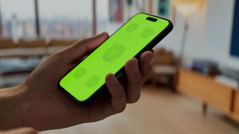 A smartphone held in a cozy home environment with modern decor Stock Footage 295209682