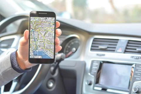 Smartphone held by man with navigation map inside a car Fotos Stock