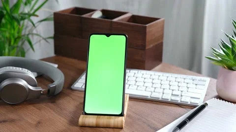 Smartphone in a holder on office table Stock Footage 168259557