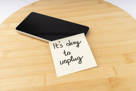 Smartphone with 'It's Okay to Unplug' Note on Wooden Board - Promoting Digi.. Stock Photos