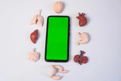 A smartphone with a key green screen centered and neatly framed by various .. Stock Photos