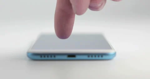 The smartphone lies on the table and the man uses it Stock Footage 97907304