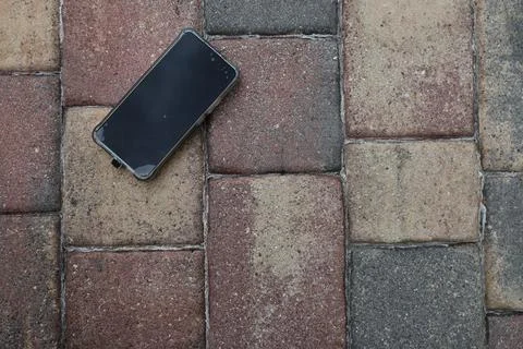 Smartphone on low Perspective Brick Pavement Pattern Outdoor Surface Stockfoto's