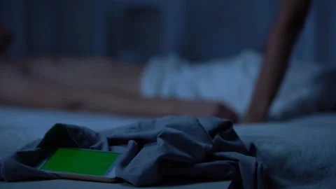 Smartphone lying on bed, couple making love on background, green screen Stock Footage 98143962