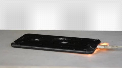 Smartphone lying on table and charging, ignited by overheating battery, sparks a Video stock 261523973
