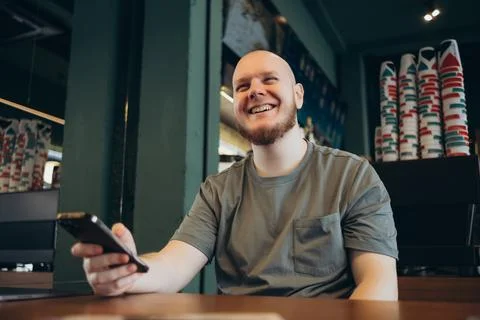 Smartphone man sms texting drinking at cafe summer. Foto stock