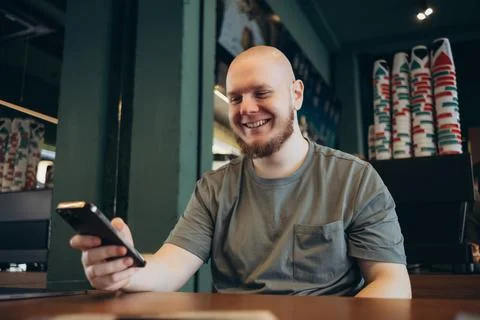 Smartphone man sms texting drinking at cafe summer. Stock Photos