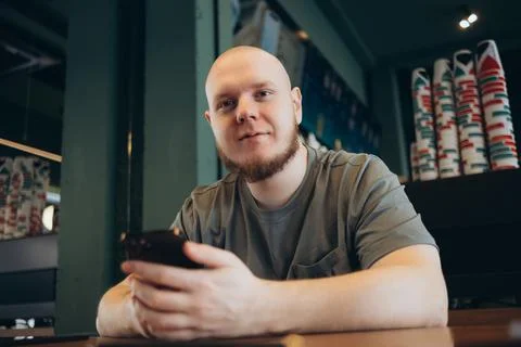Smartphone man sms texting drinking at cafe summer. Stock Photos
