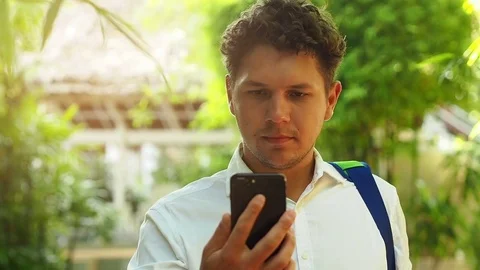 Smartphone man using mobile cell smart phone outdoors in summer Stock Footage