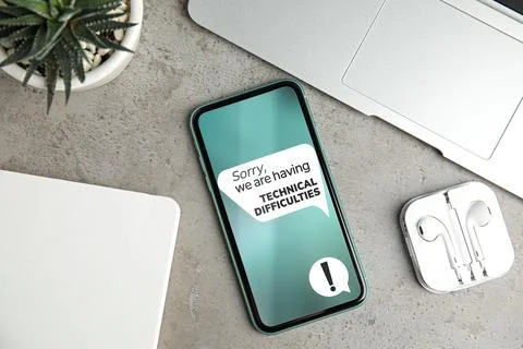 Smartphone with message Sorry We Are Having Technical Difficulties. Devices.. Stock Photos