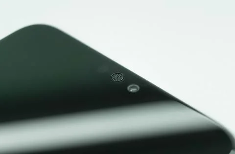 Smartphone micro speaker above the screen close-up. The top of the mobile phone Stock Photos
