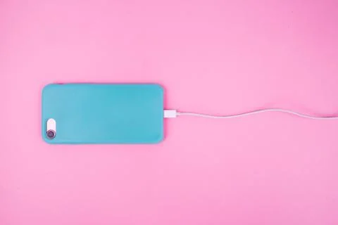 Smartphone in a mint case on a pink background. Stock Photos