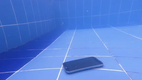 Smartphone, mobile phone falls into the pool. Underwater view angle shooting. Stock Footage 167302345