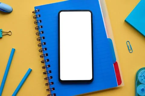 Smartphone mock up template screen on school stationery background. Stock Photos