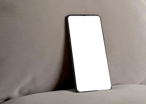 Smartphone mockup with blank screen on a neutral background. Angled mobile .. Foto stock