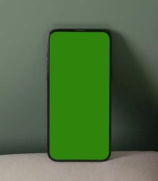 Smartphone mockup with green screen on a plain background. Vertical mobile .. Foto stock