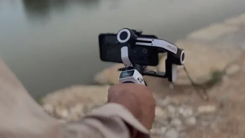 Smartphone mounted on the 3 axis stabilizer gimbal Saudi Arabia Stock Footage 239749991