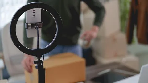 Smartphone mounted on ring light stand for live streaming product video in .. Stock Photos