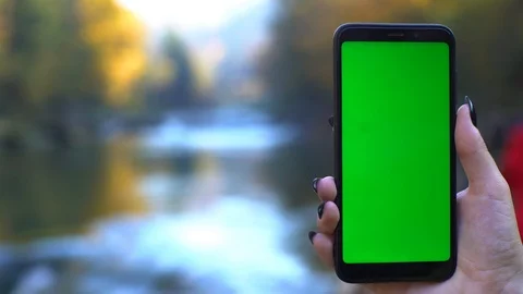 Smartphone at Nature 4k technologies concept: mobile phone with green screen Stock Footage 119443878