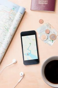 Smartphone with navigation map on screen, euro banknotes, paper map, passport Stock Photos