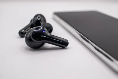 Smartphone next to the earphone. Stock Photos
