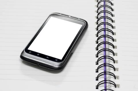 Smartphone on note book Stock Photos