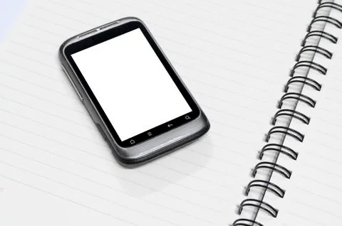 Smartphone on note book Stock Photos