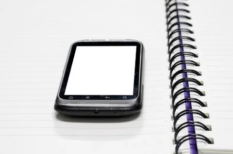 Smartphone on note book Stock Photos
