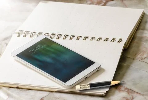 Smartphone on notebook Stock Photos