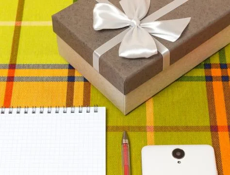 Smartphone Notepad gift box on the table Stock Photos