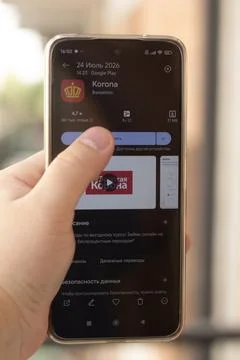 Smartphone with open Google app store for installing Golden Crown Stock Photos