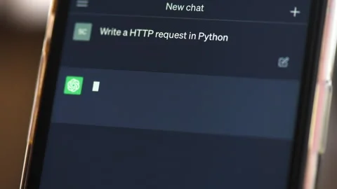 A smartphone with opened AI chat in it. User asking chat bot to write code in Stock Footage 241404791