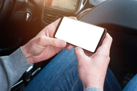 A smartphone in the passenger's hand to promote the interface of navigation a Stock Photos